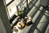 Two people meeting in a sunlit room